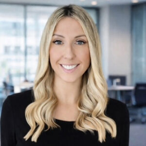 A headshot of Amy Laurie, Board Member at Framework. She is wearing a black top and is smiling.