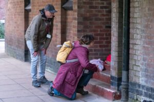 Framework's Street Outreach Team helping someone who is rough sleeping in a doorway.